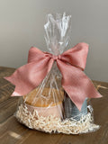 Luxury Candle Gift Set on table.  Includes Scented Candle and Air Freshener Room Spray wrapped in gift bag. 